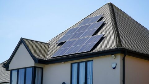 Power Plants on the Roof: How an Apartment Complex Makes Its Own Electricity White house with solar panels on the roof