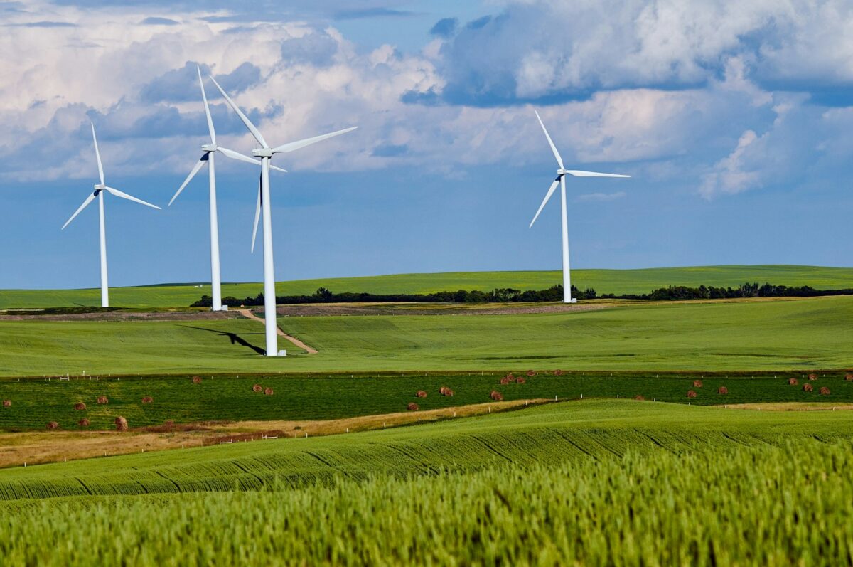Wind turbine standing in a green field