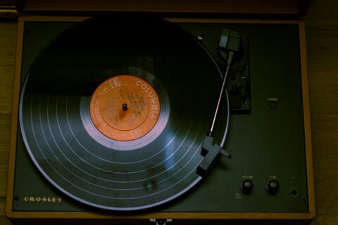 Turntable spinning a record with an orange label